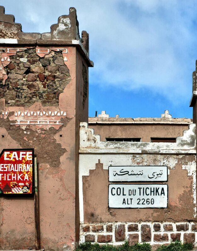 pexels-photo-30254941-30254941 Historic Col du Tichka sign and structure on a sunny day in Morocco.